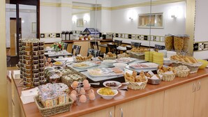 A buffet setup with various food items and beverages.