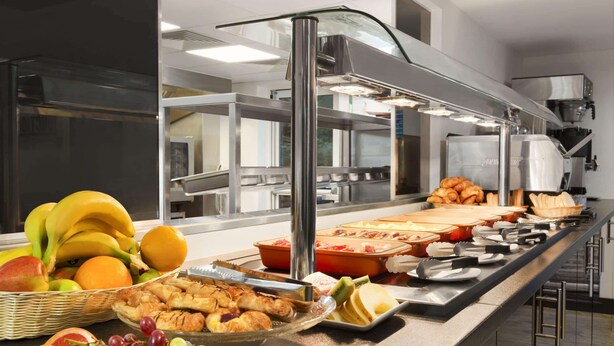 A buffet setup with various food items and a coffee machine. - Ramada by Wyndham Oxford (Oxford)