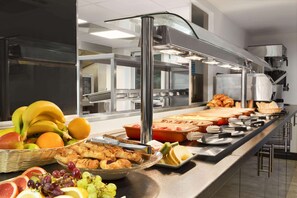 A buffet setup with various food items and a coffee machine. - Ramada by Wyndham Oxford (Oxford)