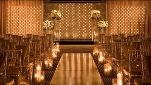 A banquet hall with rows of chairs, a long table, and candles. - Hotel ZaZa Dallas (Dallas)