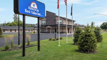 Americas Best Value Inn features a modern exterior with a flat roof and well-manicured grounds.