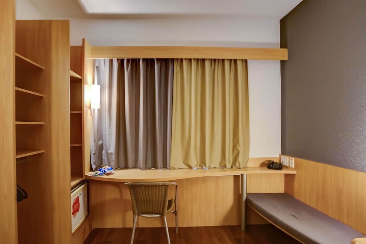 Een minibar, een bureau, een laptopwerkplek, verduisterende gordijnen