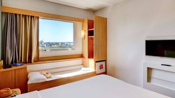 Relax in comfort with a large bed and city views from the window.
