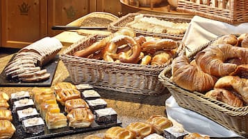 A buffet with various baked goods and pastries.