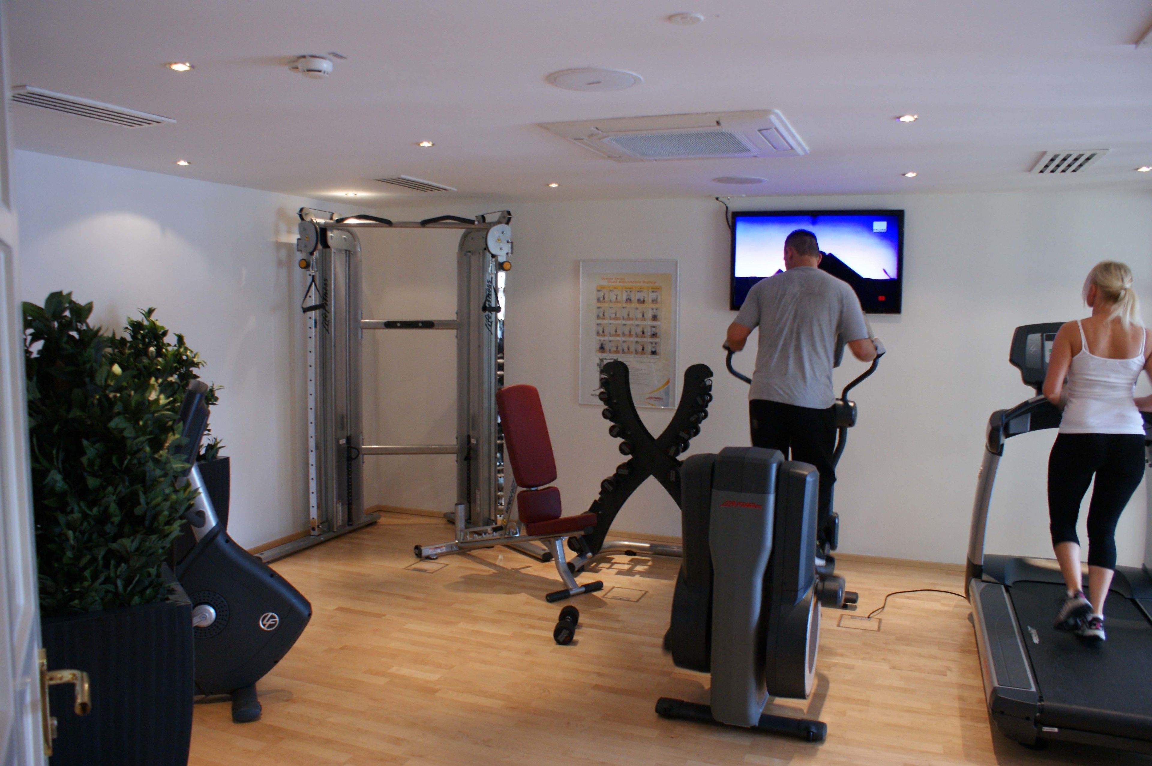 A gym with treadmills, stationary bikes, and weight machines.