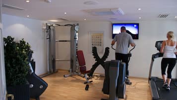 A gym with treadmills, stationary bikes, and weight machines.