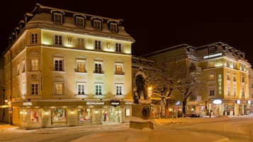 Stunning historic hotel with a traditional European facade, featuring a symmetrical design and decorative elements.