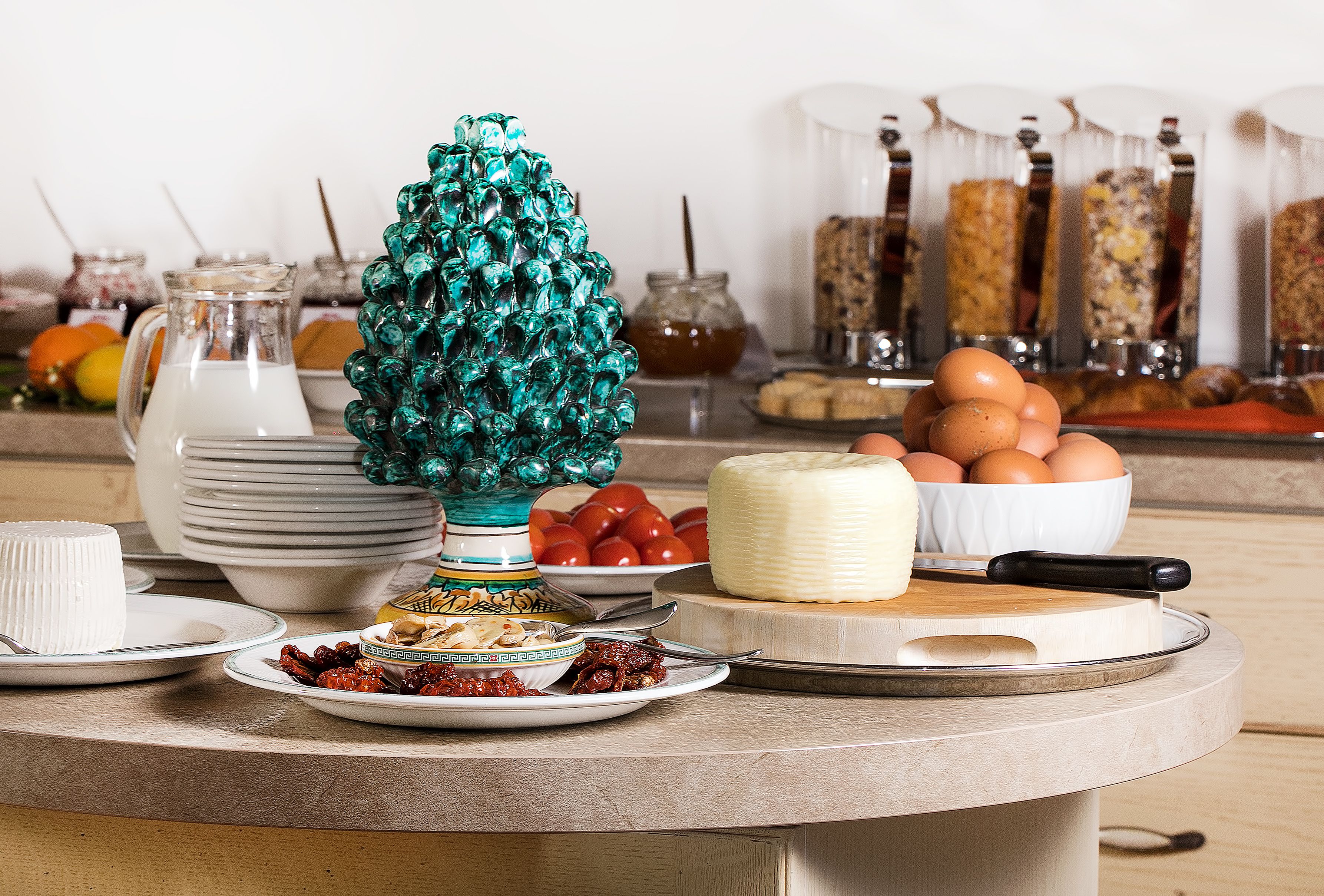 A breakfast buffet with various food items, including eggs, cheese, and condiments.