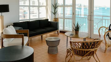 Luxury Studio Suite, 1 King Bed, Harbor View | Living area | 55-inch TV with cable channels