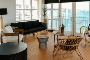 Luxury Studio Suite, 1 King Bed, Harbor View | Living area | 55-inch TV with cable channels