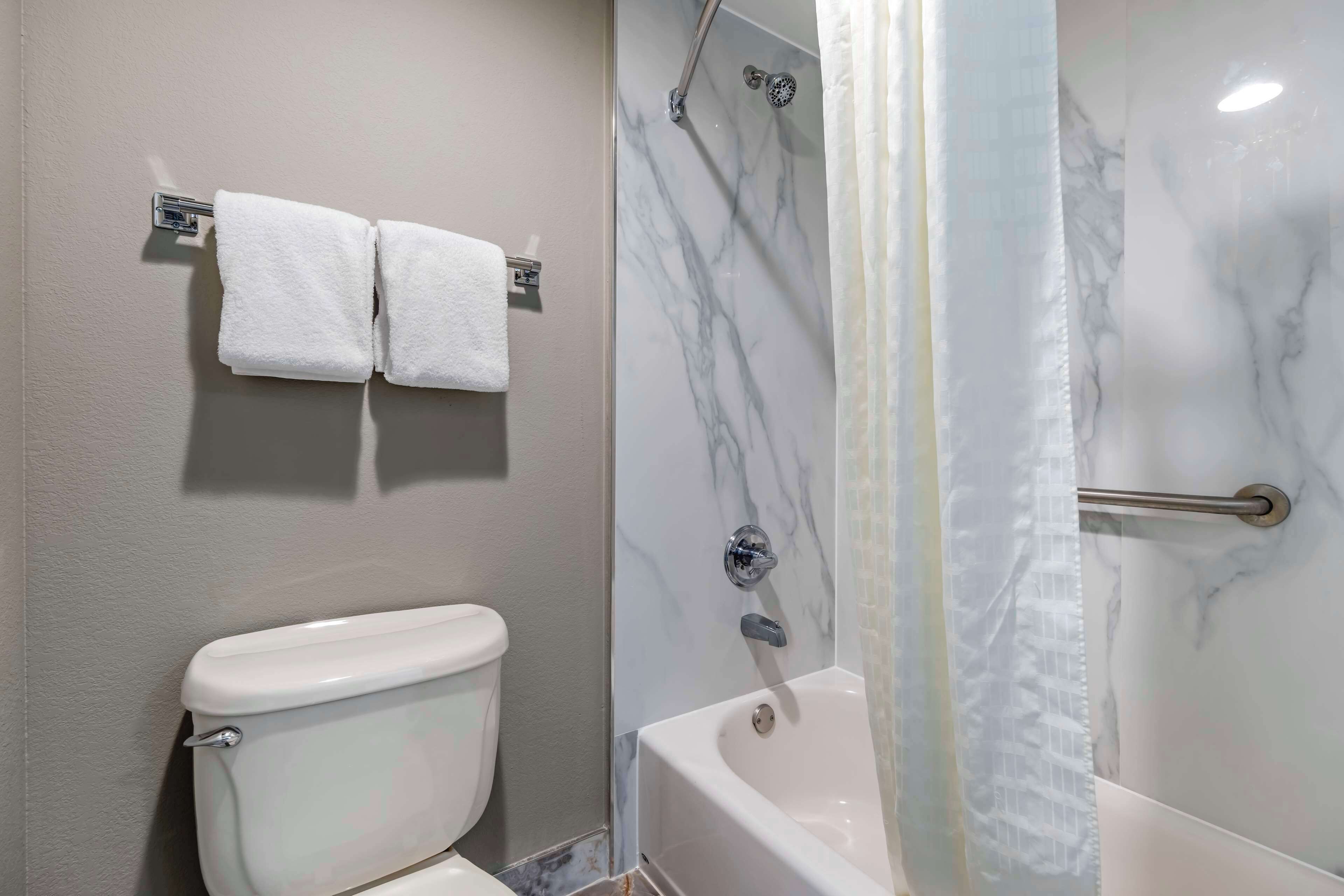 standard room, 2 queen beds, non smoking, refrigerator & microwave | bathroom | combined shower/bathtub, free toiletries, hair dryer, towels