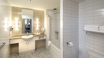 A modern bathroom with a sink, mirror, and shower.