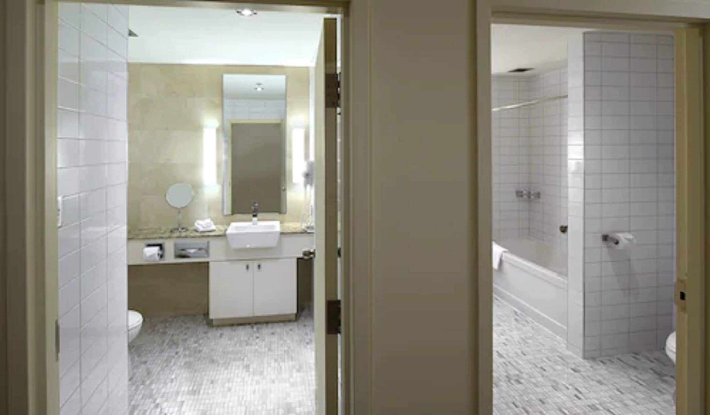 A bathroom with a sink, mirror, and toilet.