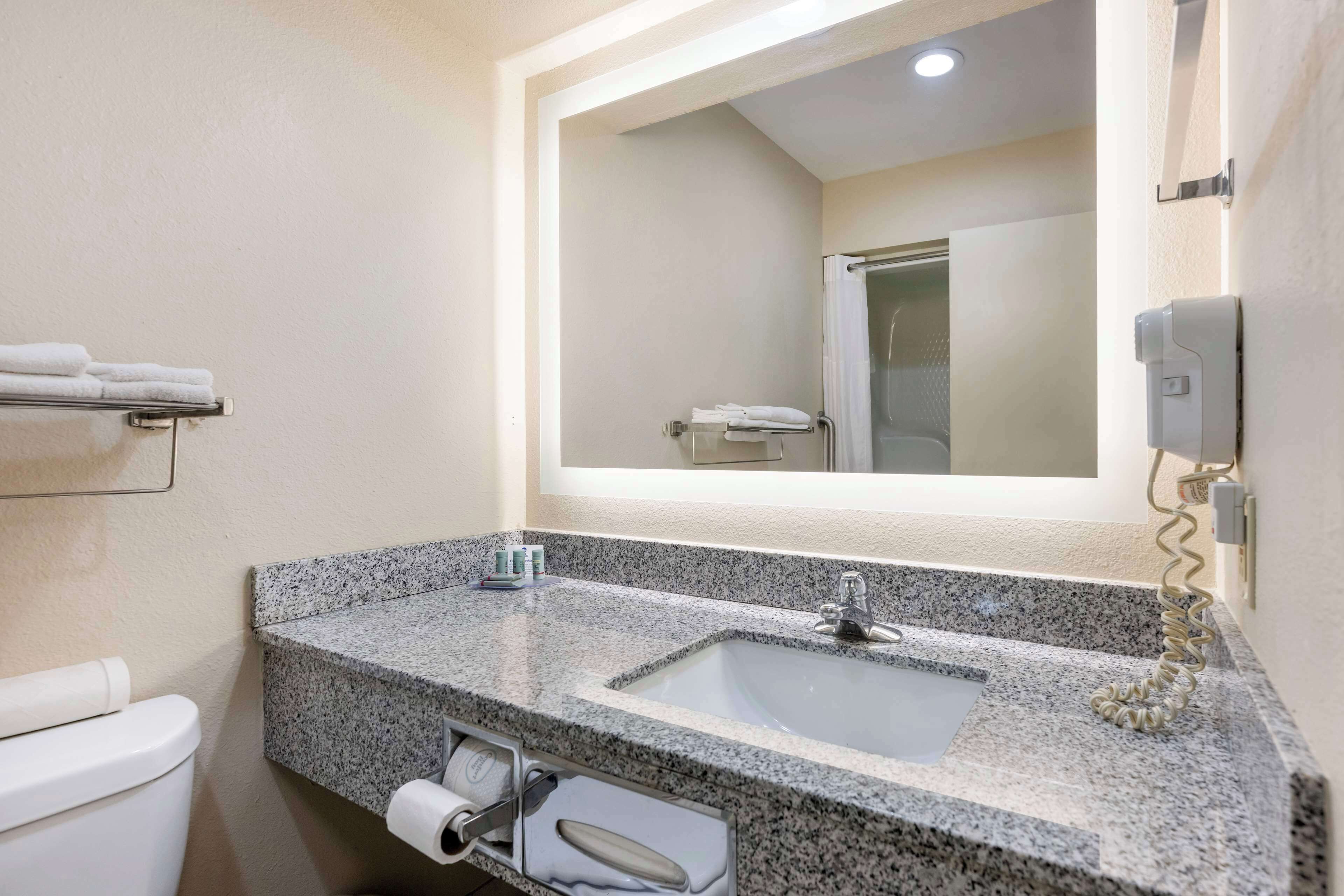 standard room, 2 queen beds, smoking, refrigerator & microwave | bathroom | combined shower/bathtub, hair dryer, towels, soap
