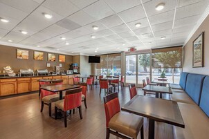 A restaurant with booths, tables, and a counter.