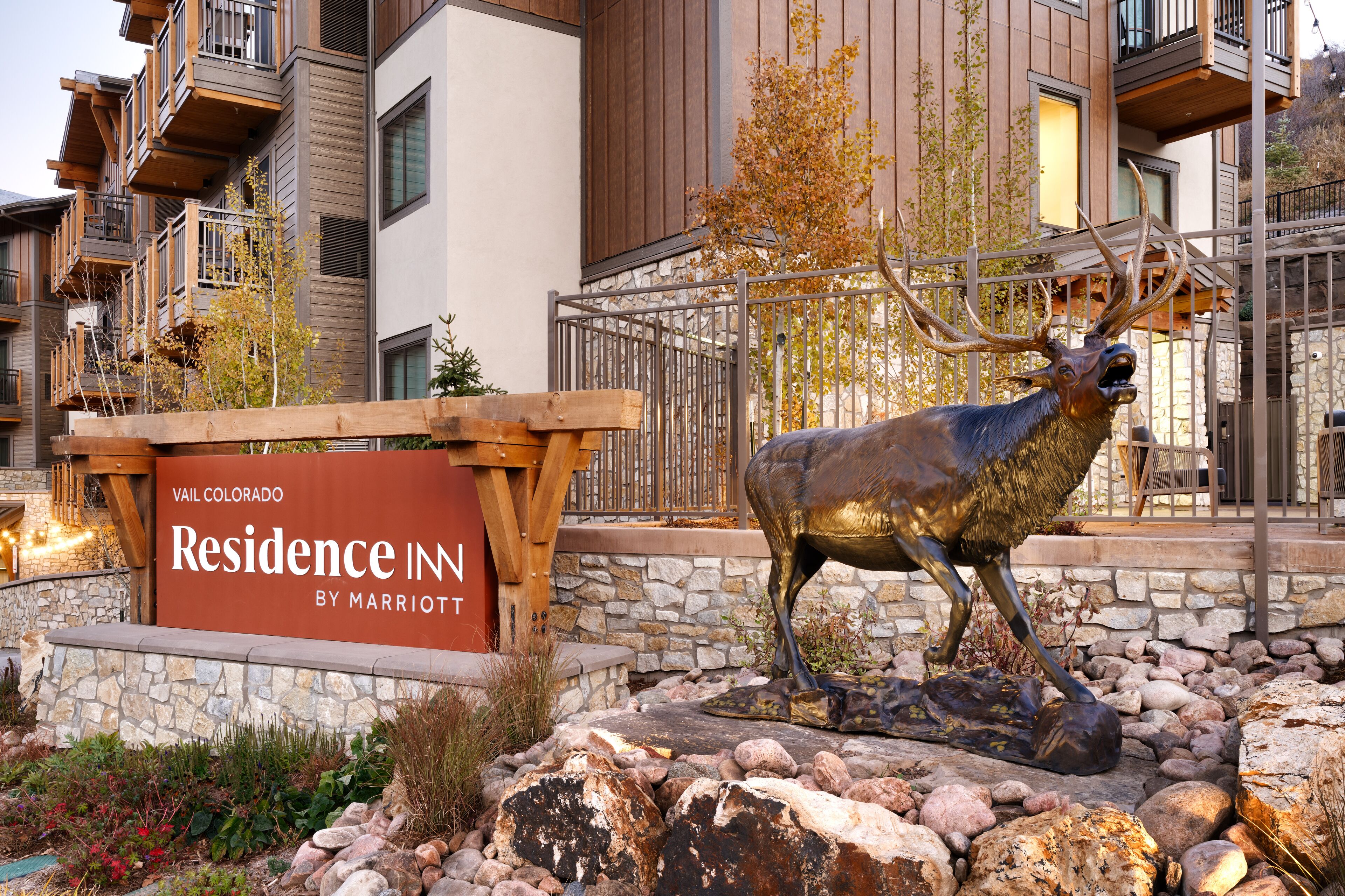 A sign for 'Vail Colorado Residence Inn by Marriott' with a deer statue in front.