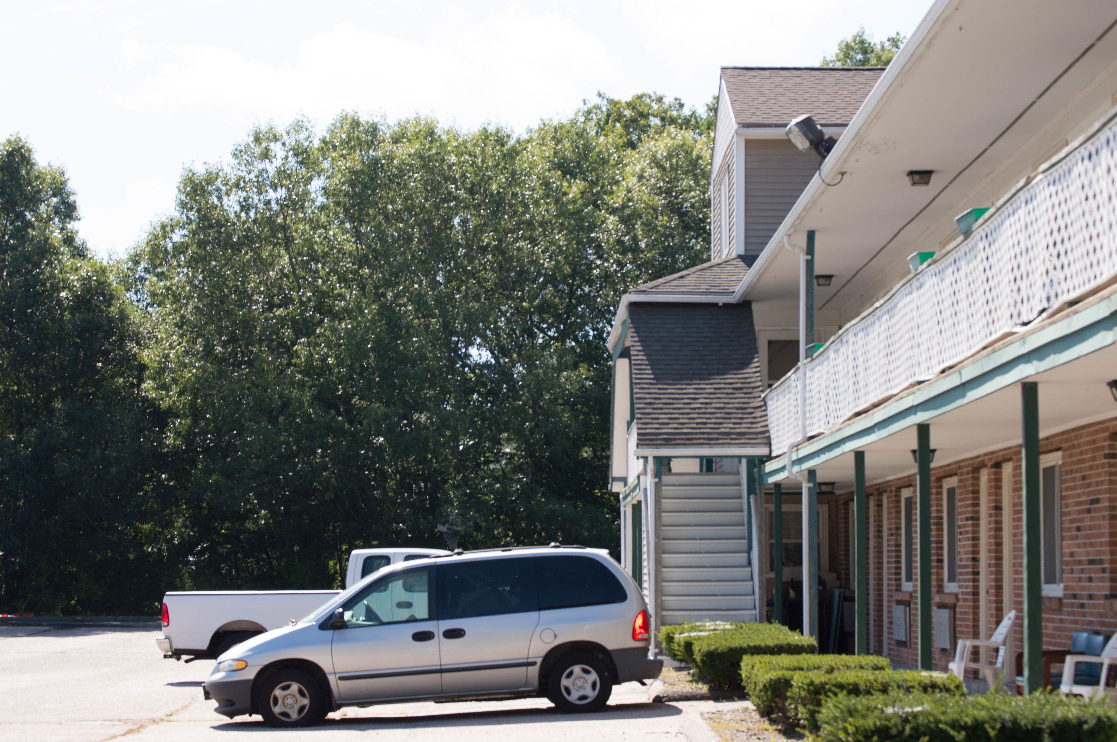 A building with a brick facade and a covered porch area.