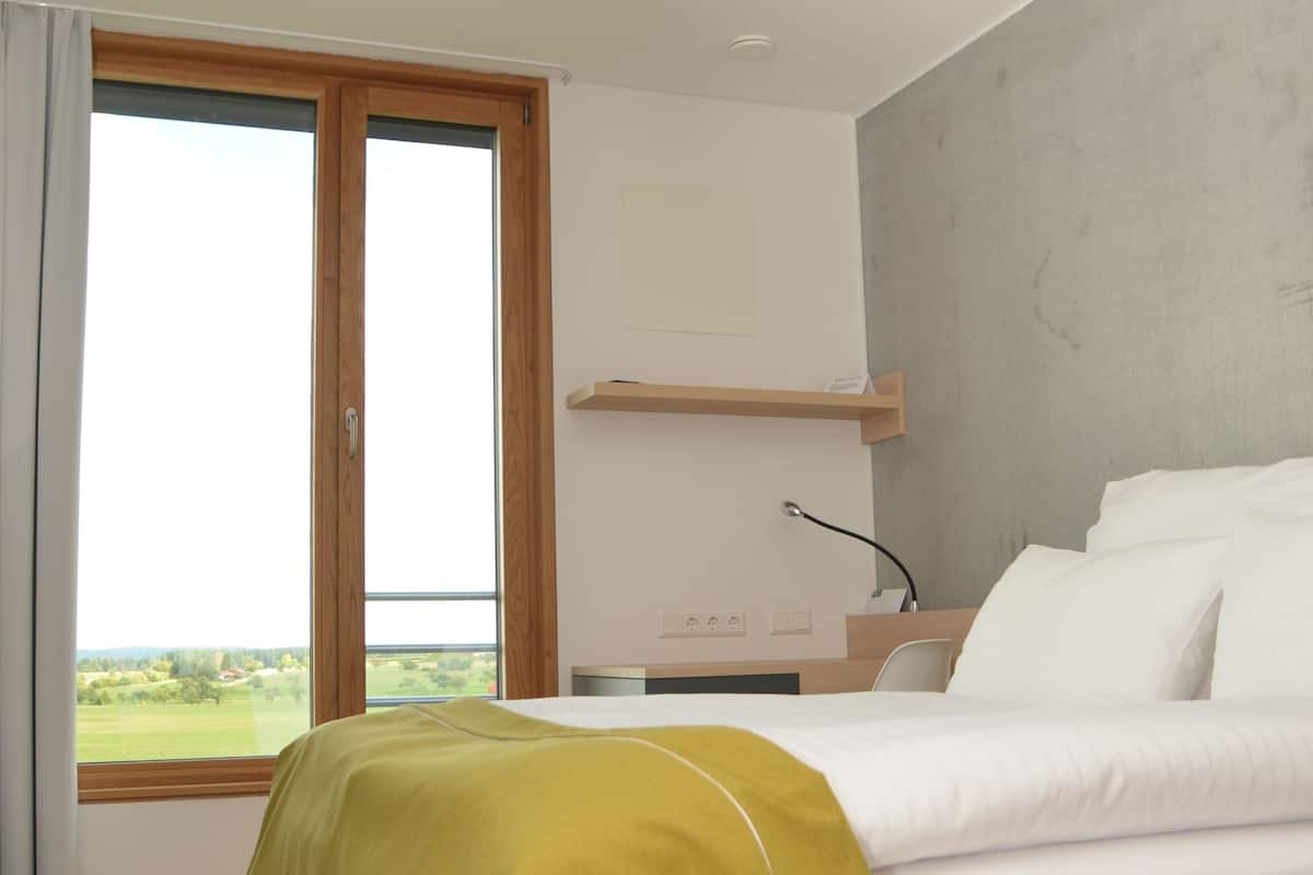 Hypo-allergenic bedding, desk, laptop workspace, blackout curtains