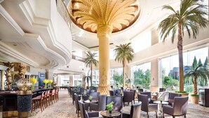 A spacious lobby with a high ceiling, large columns, and a patterned carpet. - Wyndham Beijing North Hotel (Beijing)
