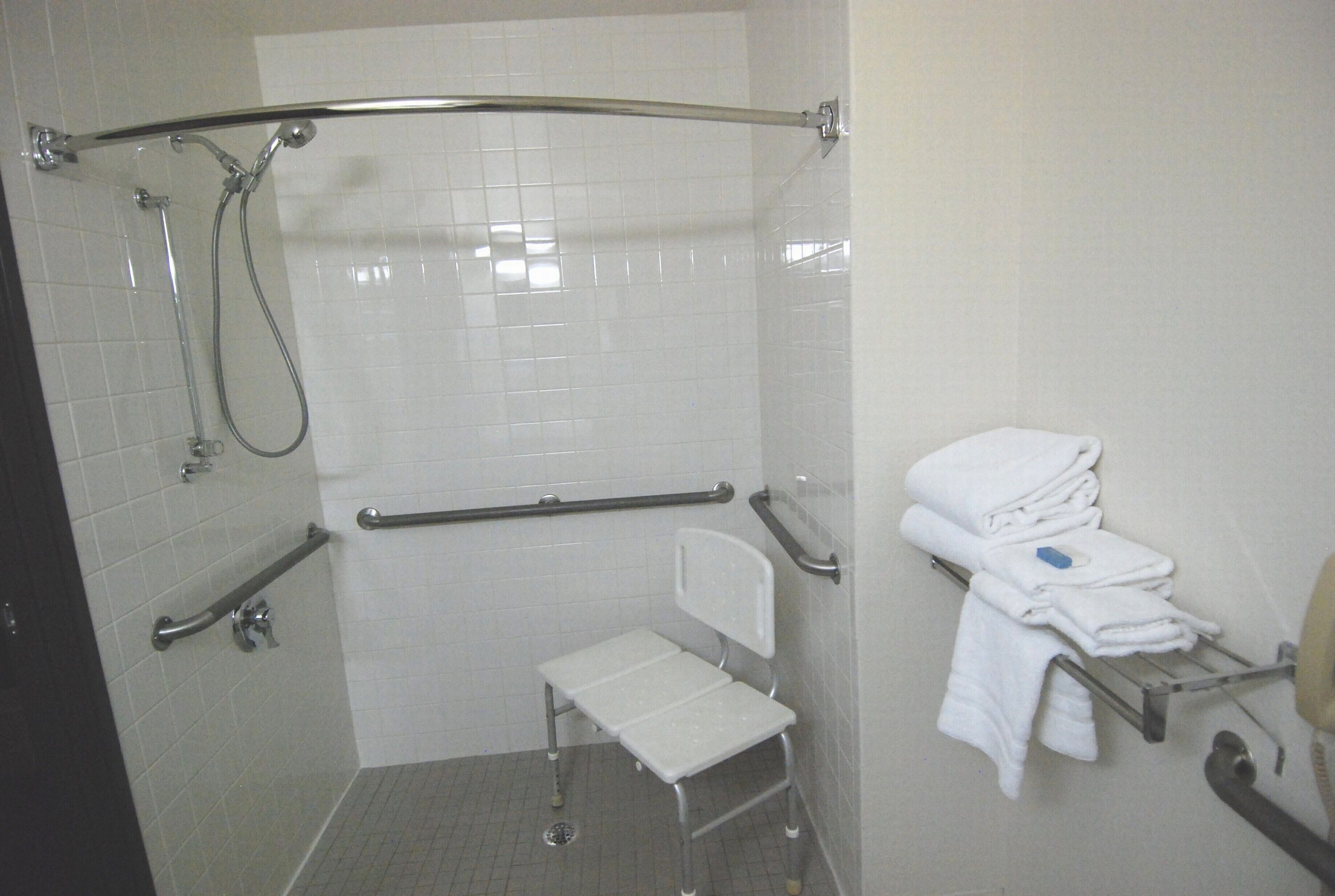 ada accessible roll-in-shower, deluxe one queen non-smoking, non pet friendly | bathroom | combined shower/bathtub, free toiletries, hair dryer, towels