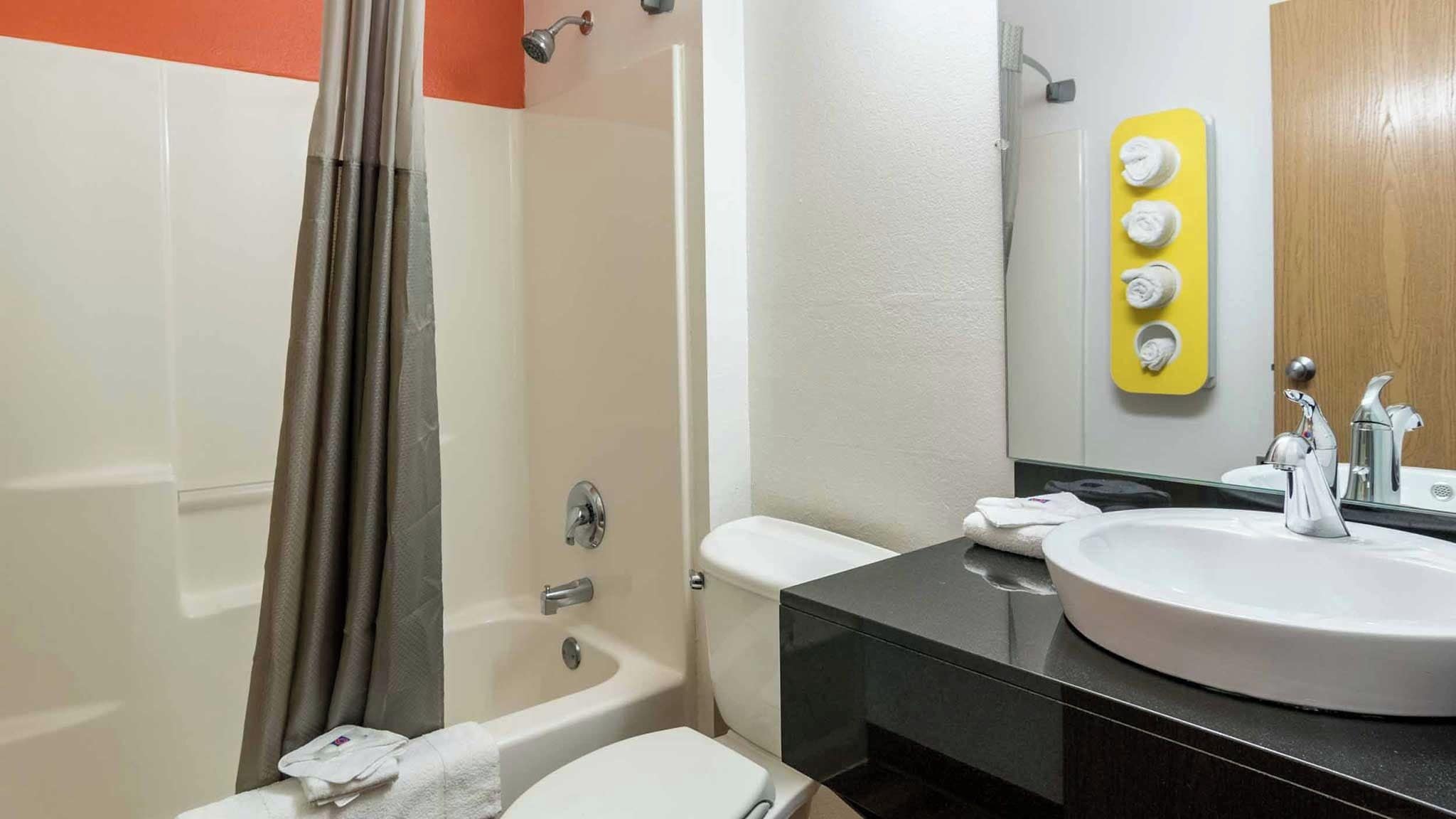 A bathroom with a bathtub, toilet, and sink.