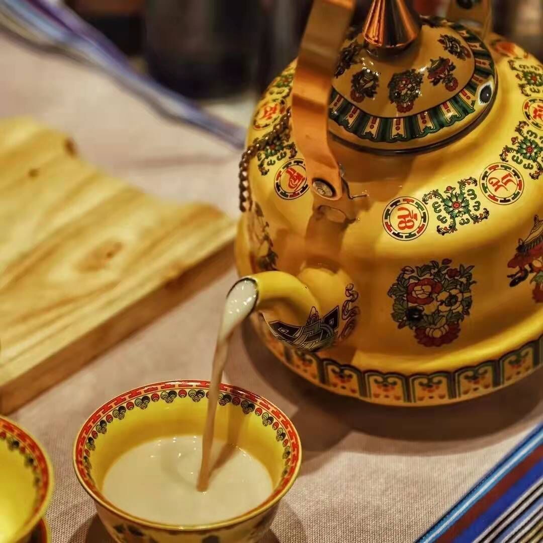 A traditional tea set with a teapot and cups, featuring intricate designs and patterns.