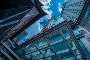 A modern building with a glass facade and a traditional roof. - Merry Hotel Shanghai (Shanghai)
