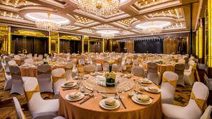 A banquet hall with round tables, white chairs, and chandeliers. - Merry Hotel Shanghai (Shanghai)
