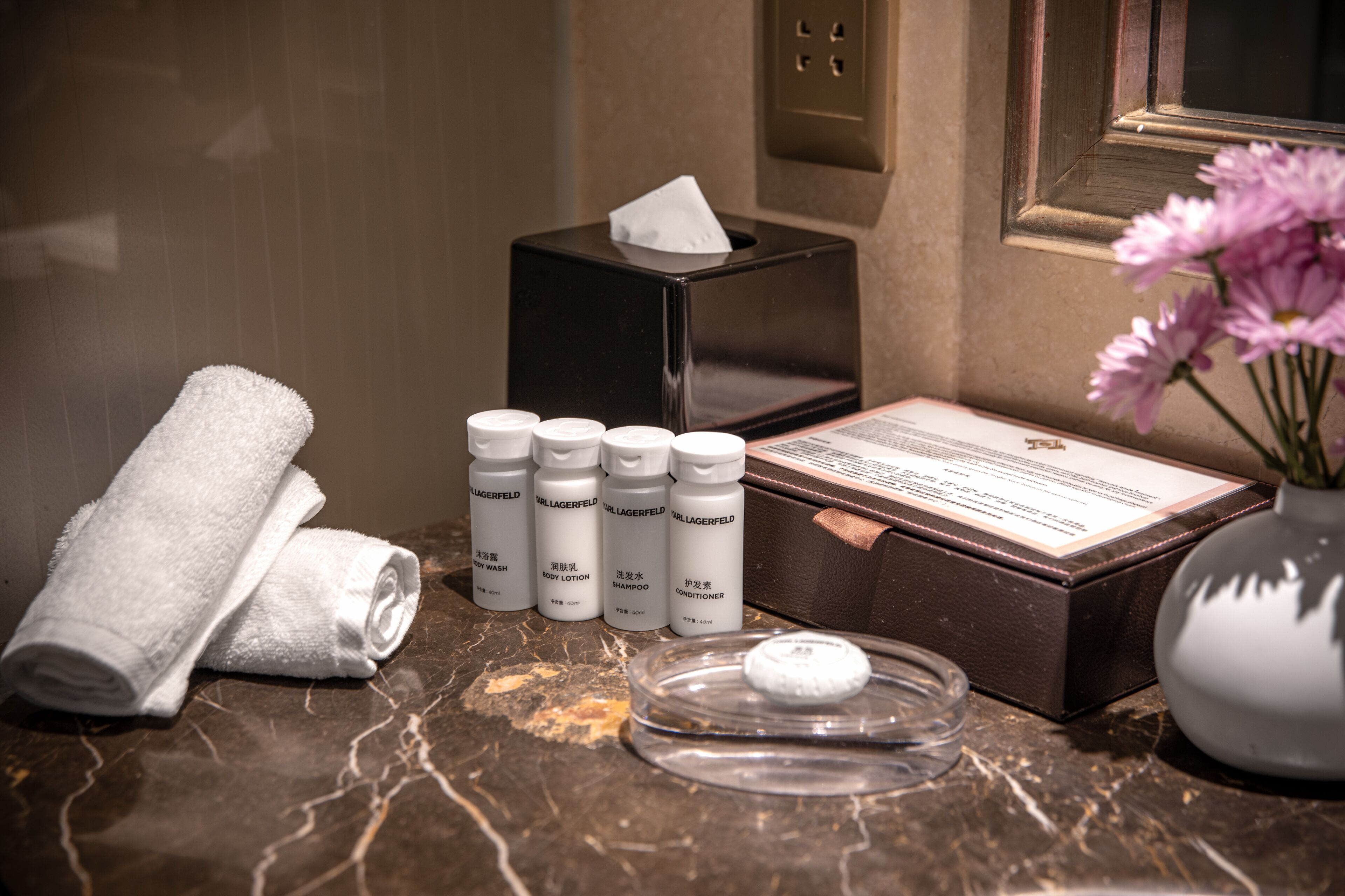 designer toiletries, hair dryer, bathrobes, slippers