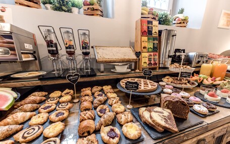 A bakery display with various pastries and a coffee machine.