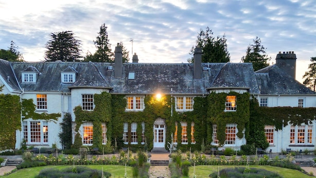 A large, historic building with a symmetrical facade, a central entrance, and a well-maintained garden with a stone pathway leading to the entrance. - Rufflets St Andrews (St. Andrews)