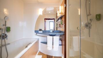 Separate bathtub and shower, hair dryer, towels