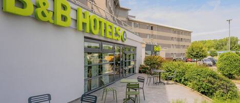 A B&B hotel exterior with a patio area featuring outdoor seating.