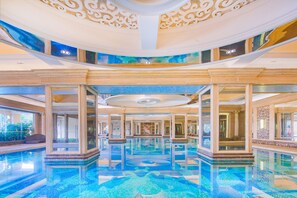 A large indoor swimming pool with a tiled floor and a high ceiling with ornate decorations. - Chateau Star River Guangzhou (Guangzhou)