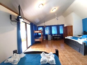 Cozy retreat with a single bed, desk, and kitchenette, perfect for a compact stay.