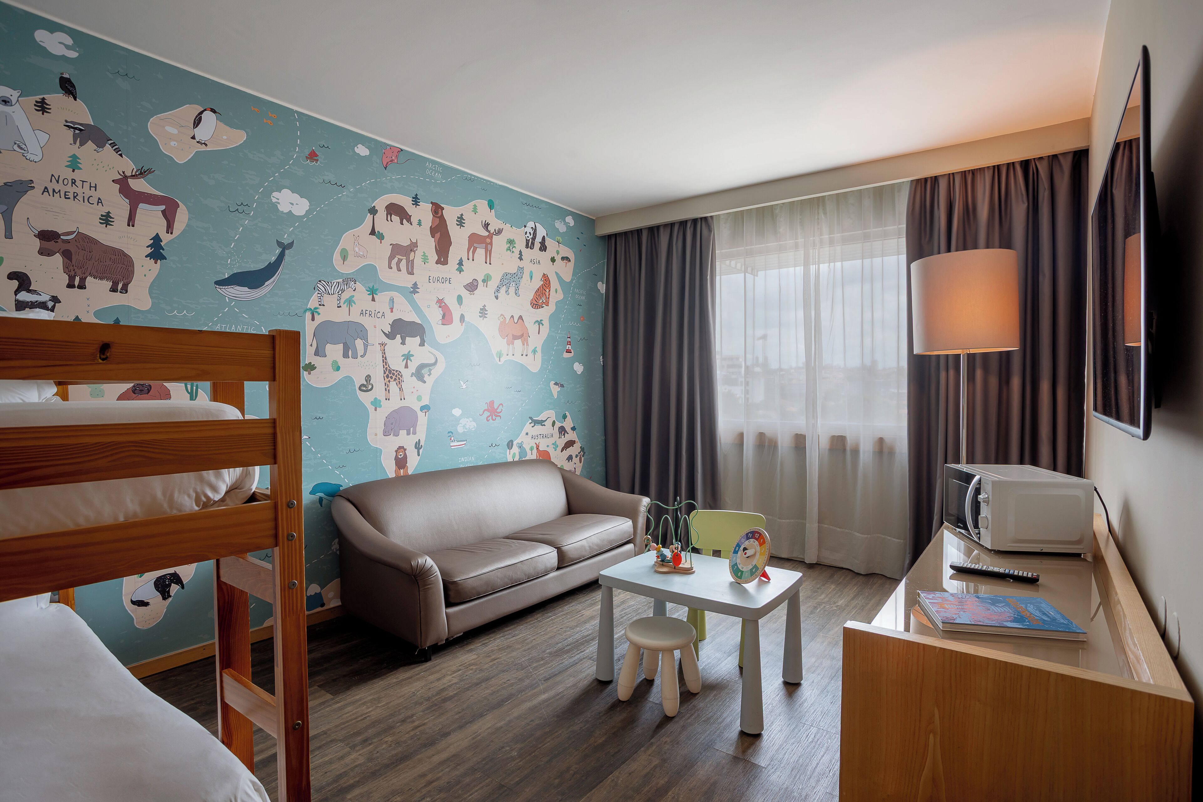 family room | minibar, in-room safe, desk, blackout curtains