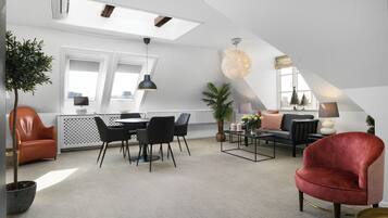 Grand Suite | Living area | 32-inch flat-screen TV with cable channels, books