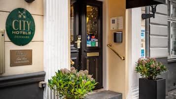 Classic Copenhagen hotel entrance with a black awning and white lettering.