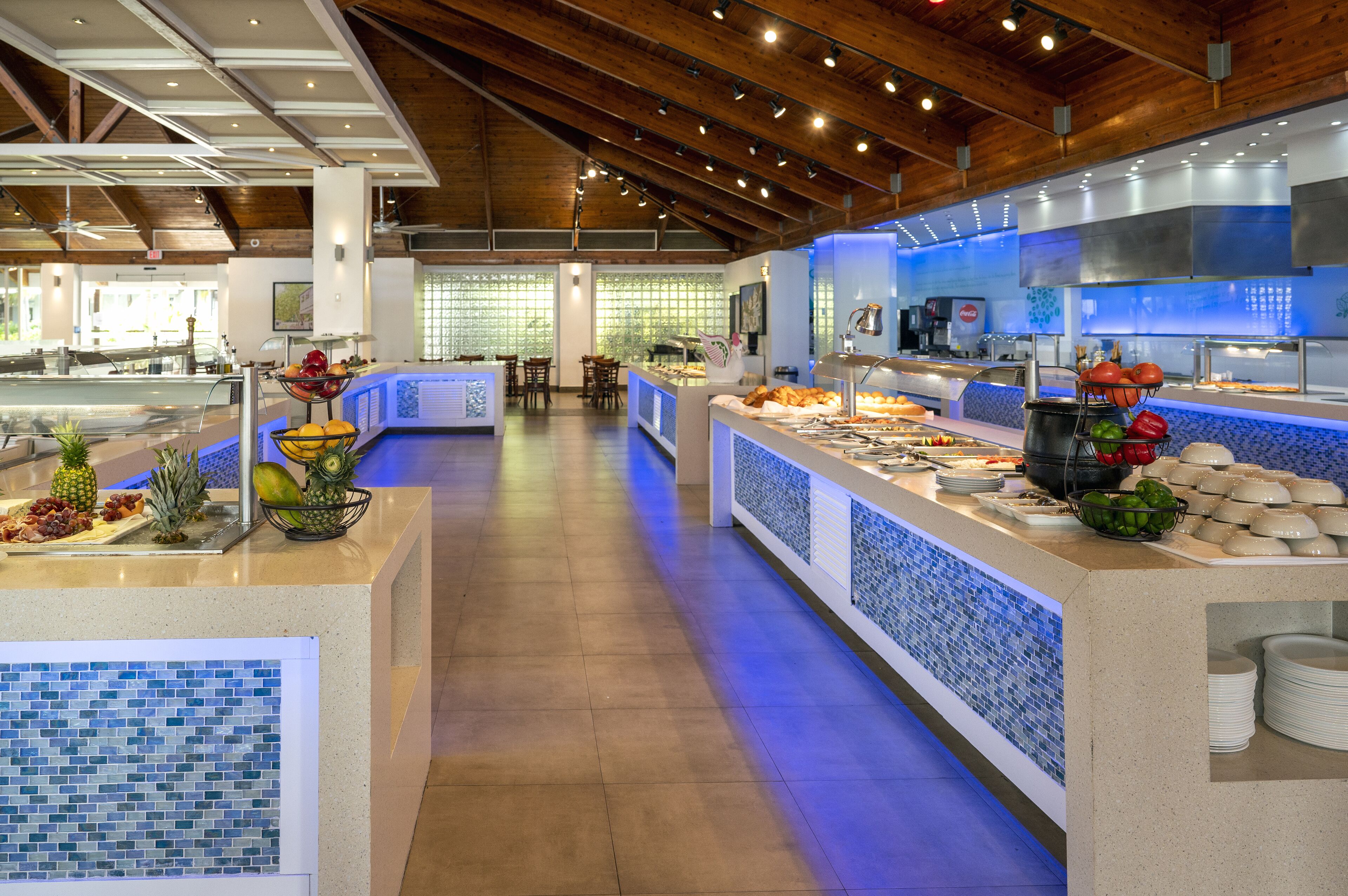 A buffet area with a variety of food items and a seating area in the background.