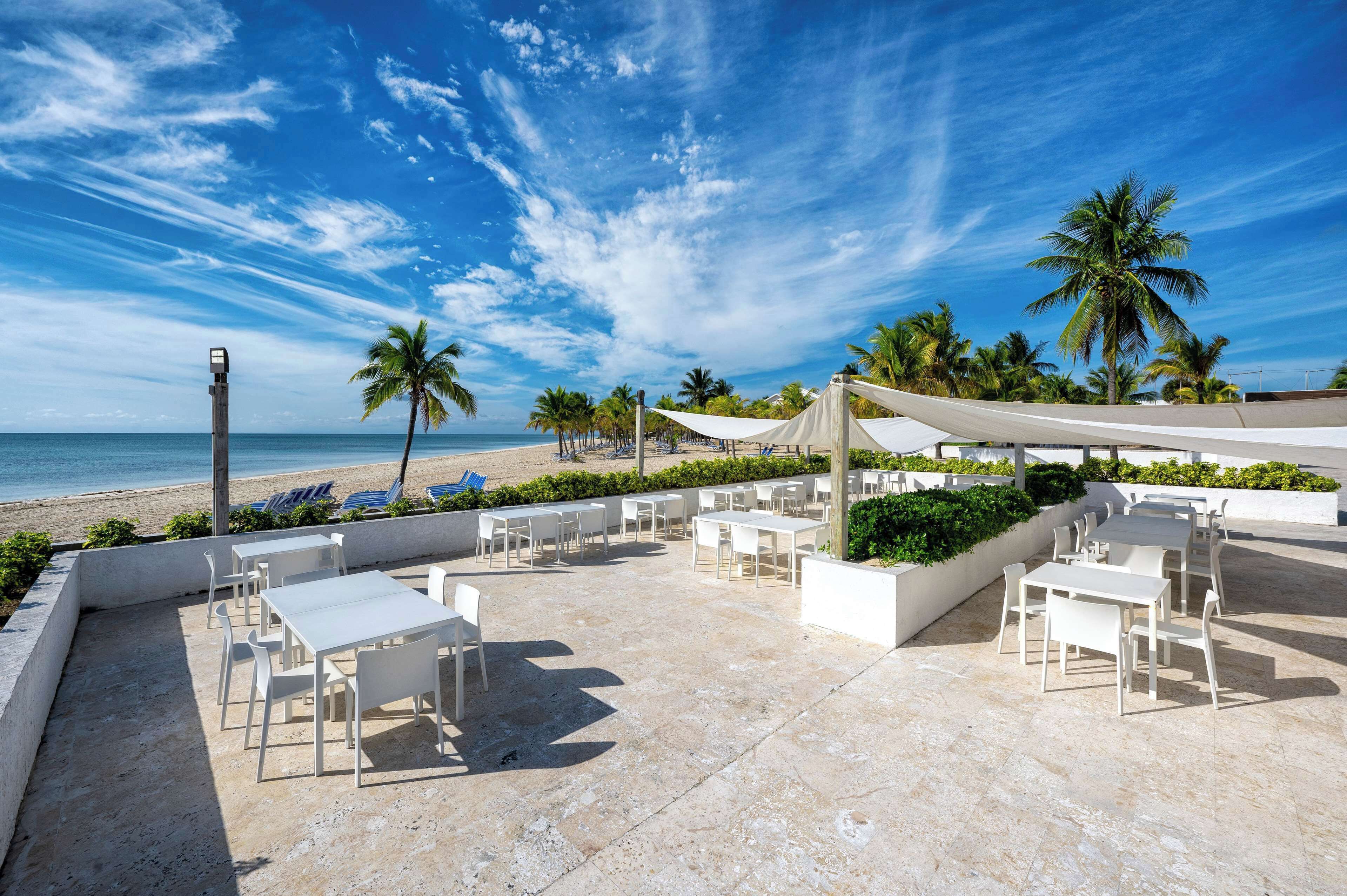 On the beach, white sand, sun loungers, beach towels