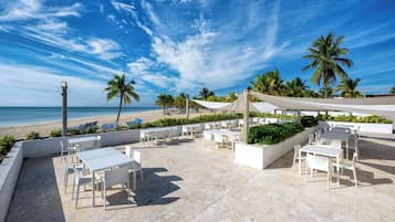 On the beach, white sand, sun loungers, beach towels