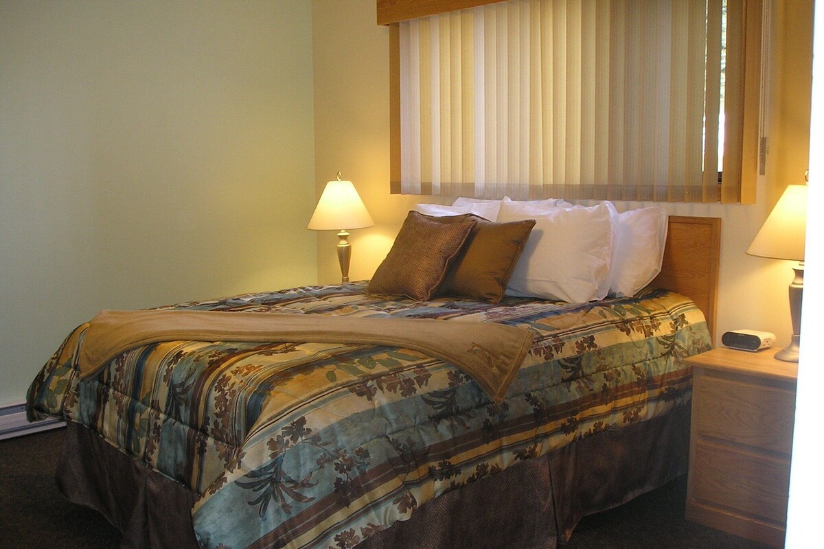 Laptop workspace, iron/ironing board, bed sheets