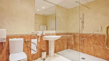 Ein modernes Badezimmer mit Toilette, Waschbecken und einer Duschkabine.
