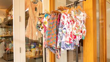 A clothing rack with various garments in a store.