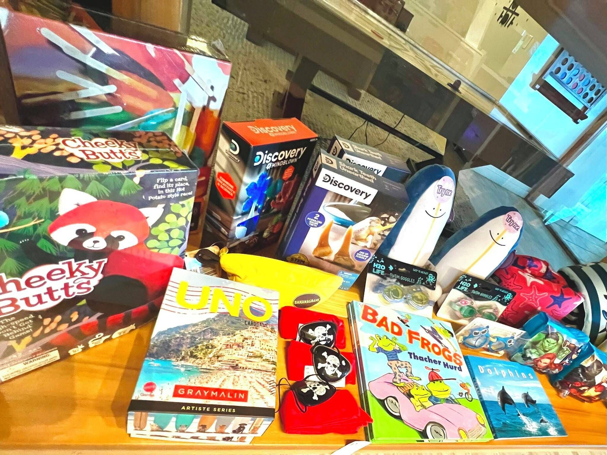 A variety of children's books and toys on a table.