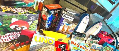 A variety of children's books and toys on a table.