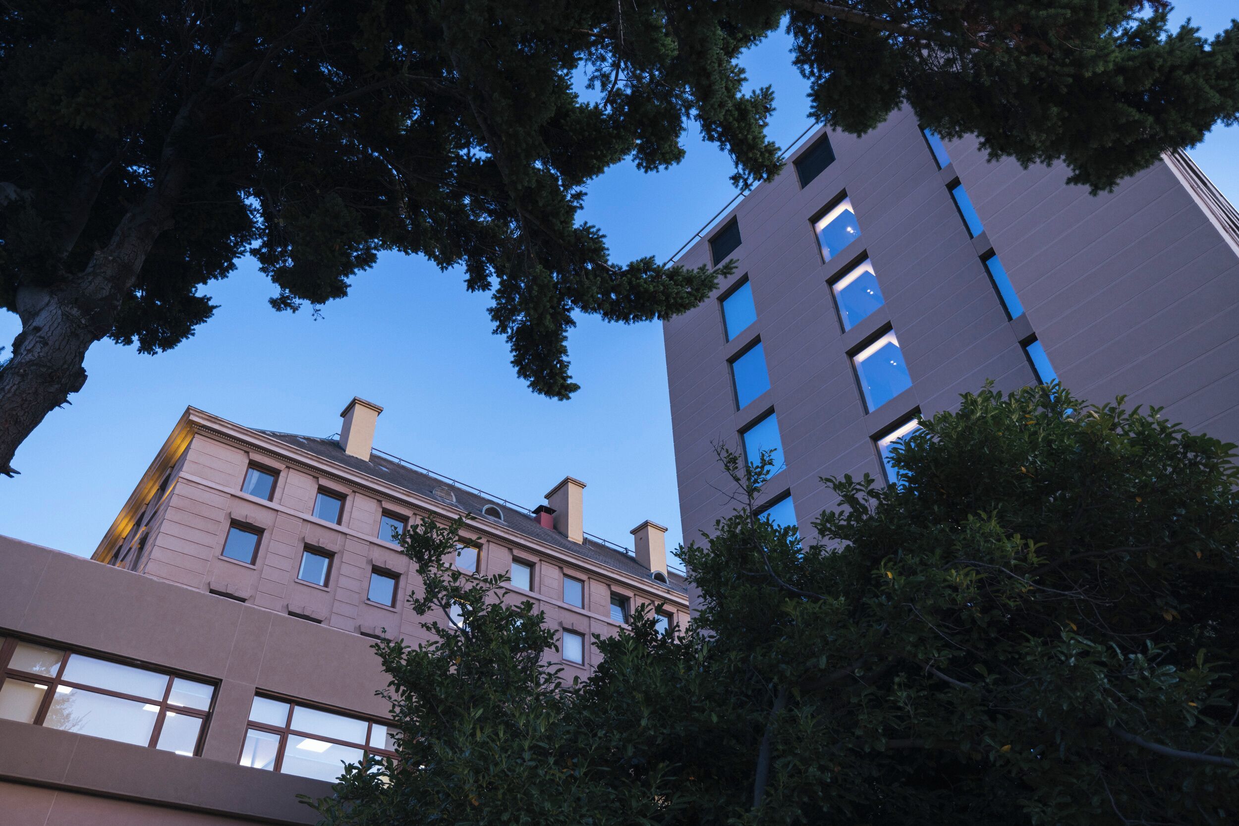 A multi-story building with a modern architectural style, featuring a mix of rectangular and square windows.
