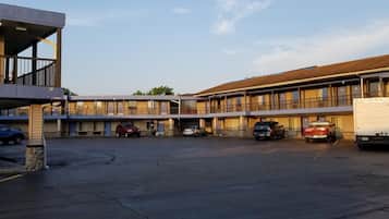 Guests can enjoy stunning views from the upper-floor balconies overlooking the spacious parking lot.