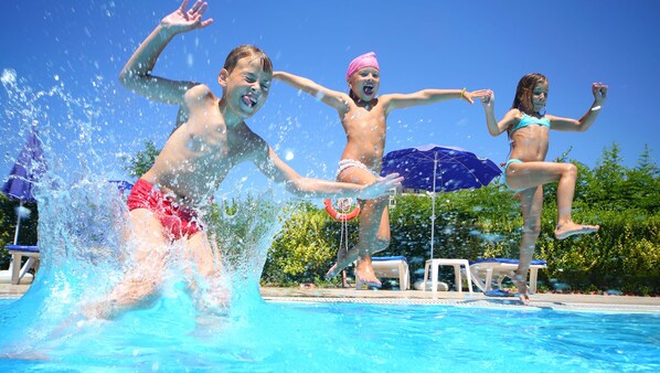 Outdoor pool, open 10:00 AM to 10:00 PM, pool loungers