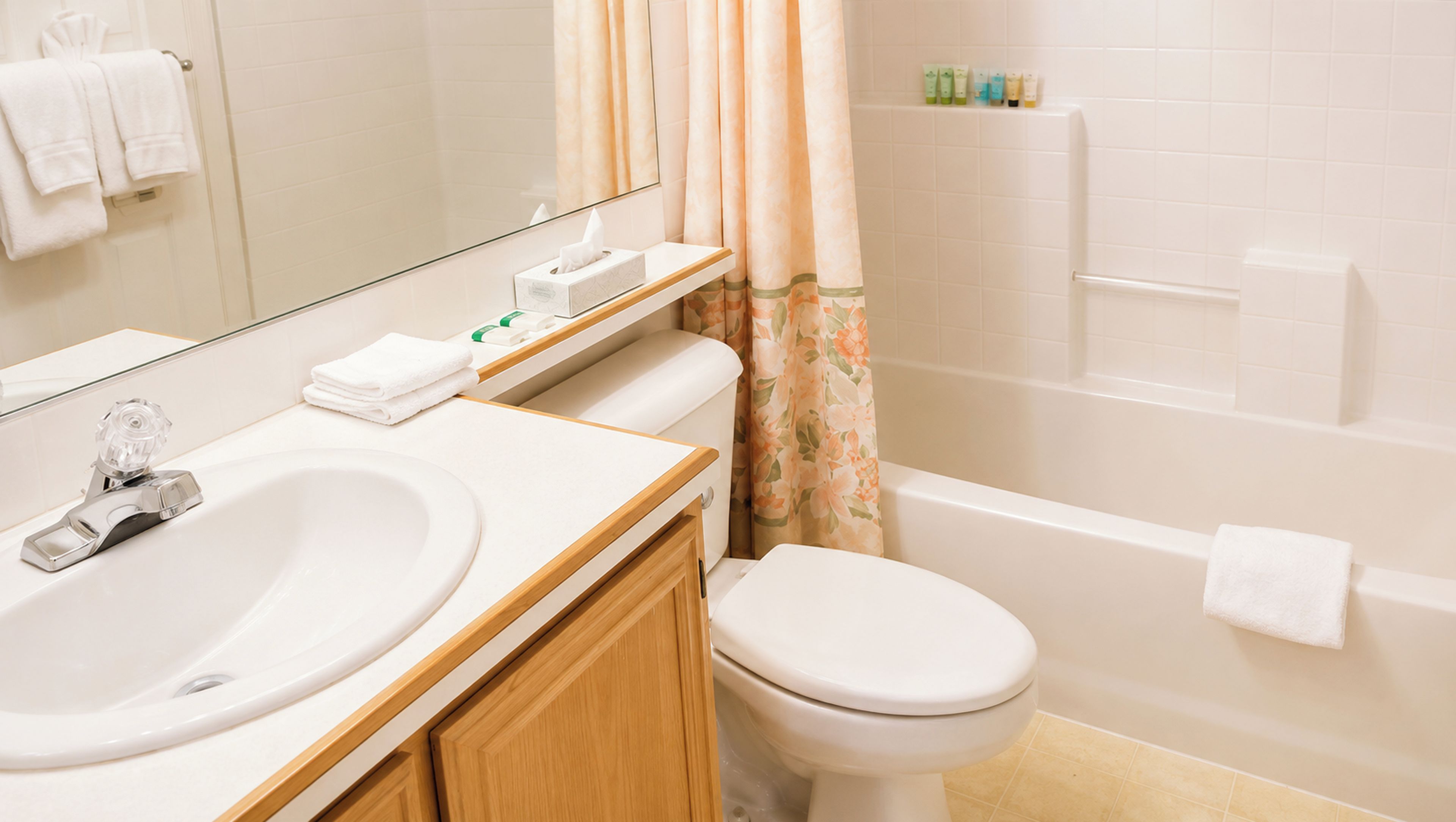 A bathroom with a sink, toilet, and bathtub.